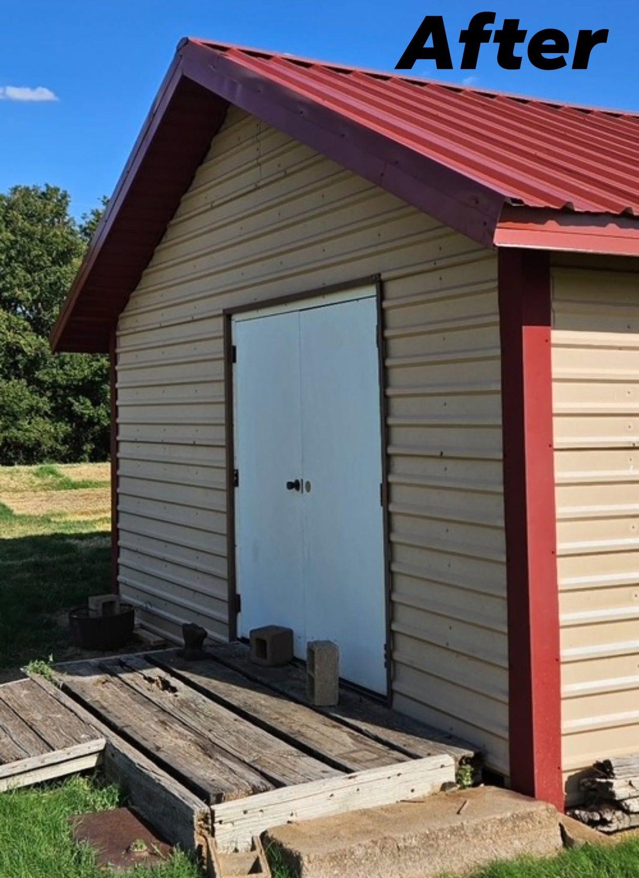 The same barn after its new red metal roof was installed