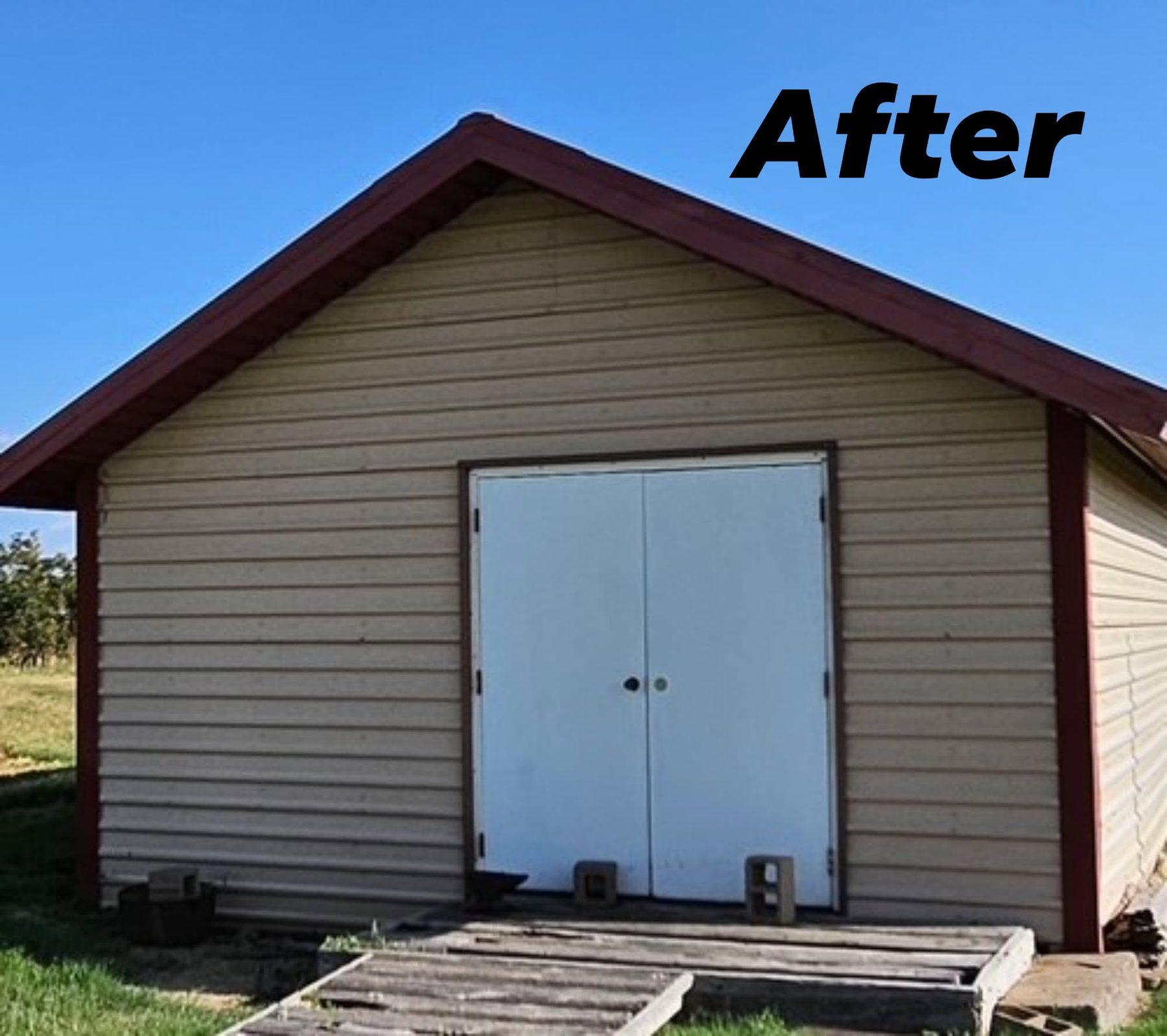 The same barn after its new red metal roof was installed